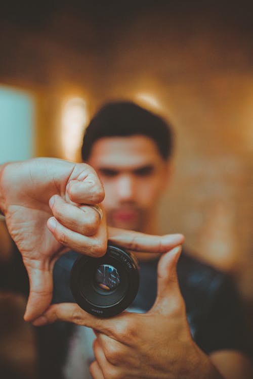 A Man Showing A Camera Lens