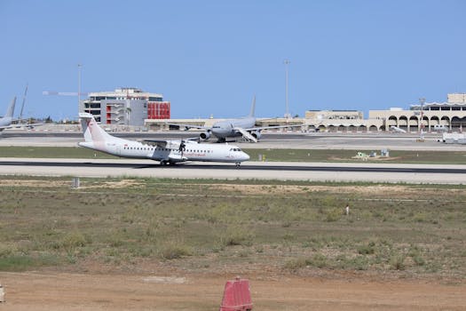 A commercial airplane preparing for takeoff on a sunny day at the airport.
