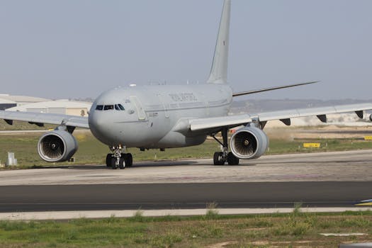 Military aircraft stationed on a runway ready for takeoff, showcasing aviation technology.