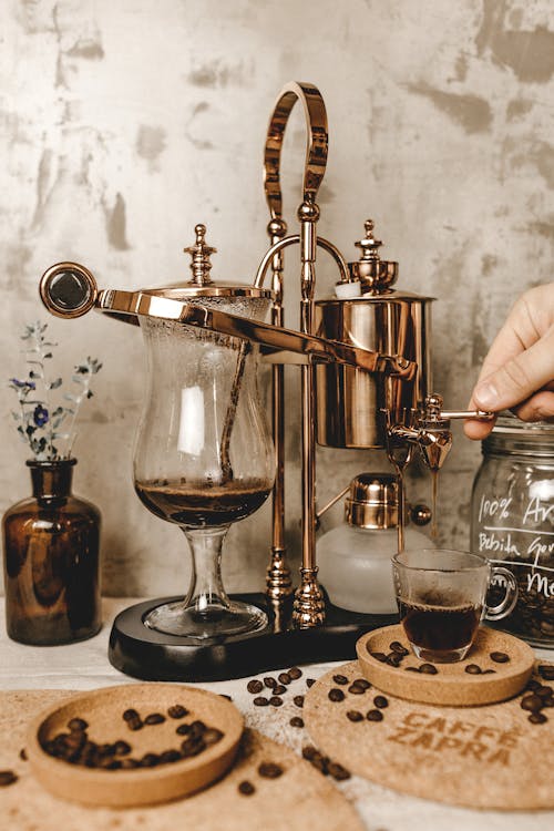 Free Half-full Clear Glass Mug Beside Coffee Machine Stock Photo