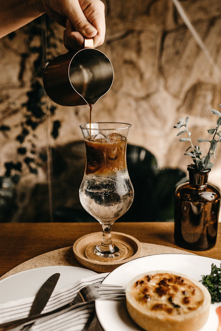 Pouring Coffee On Glass Cup