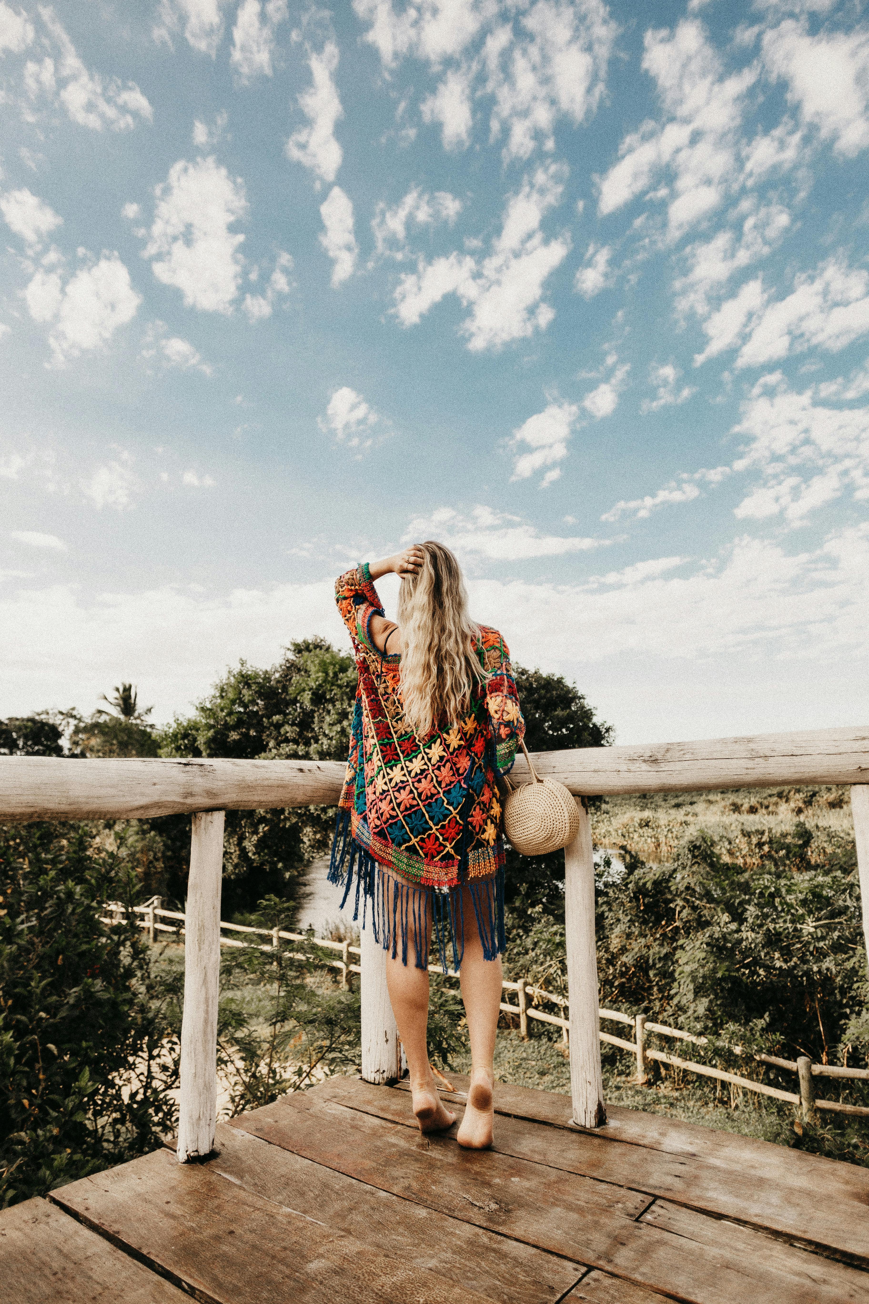 photo of woman touching her hair