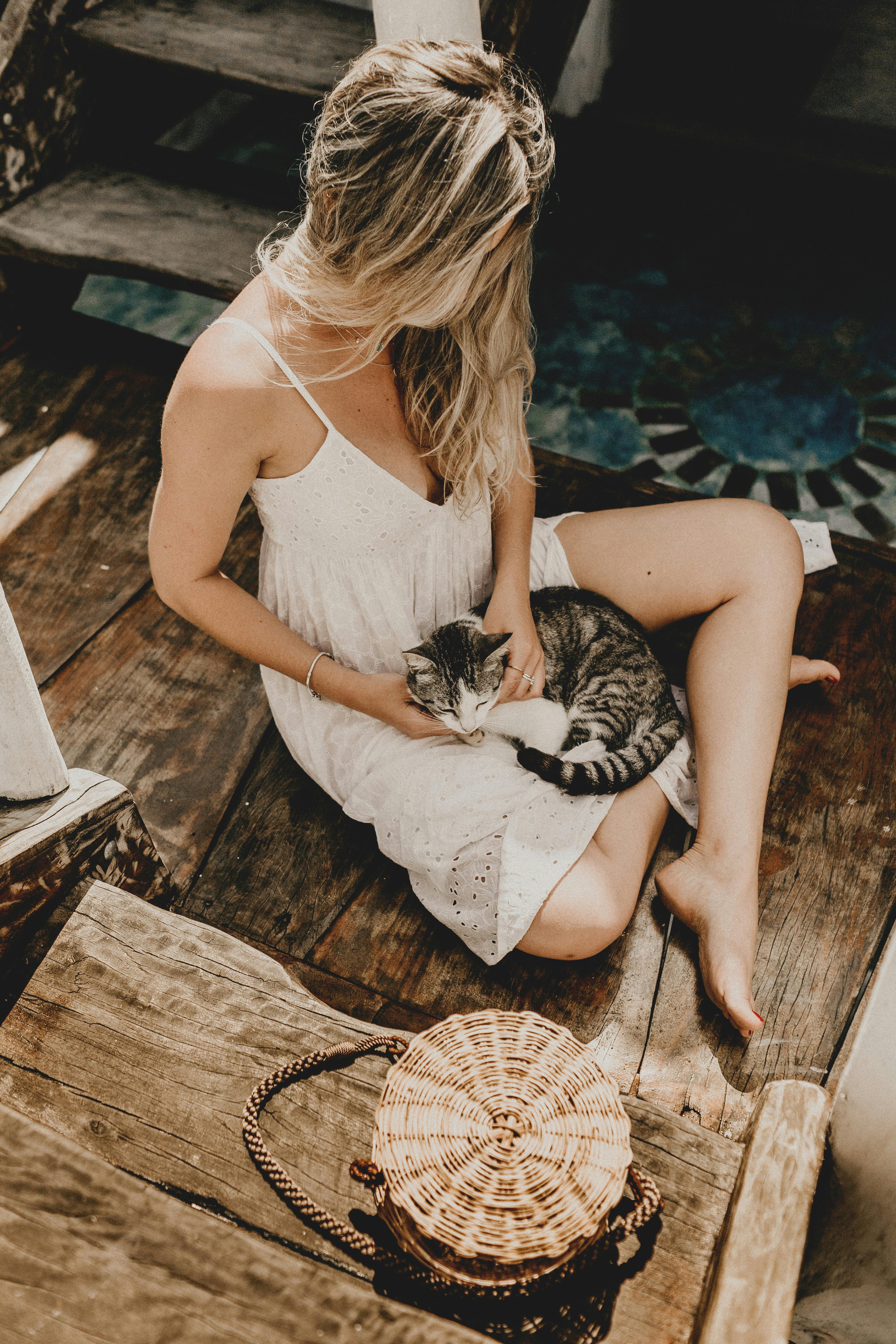 Woman holding her cat. | Photo: Pexels