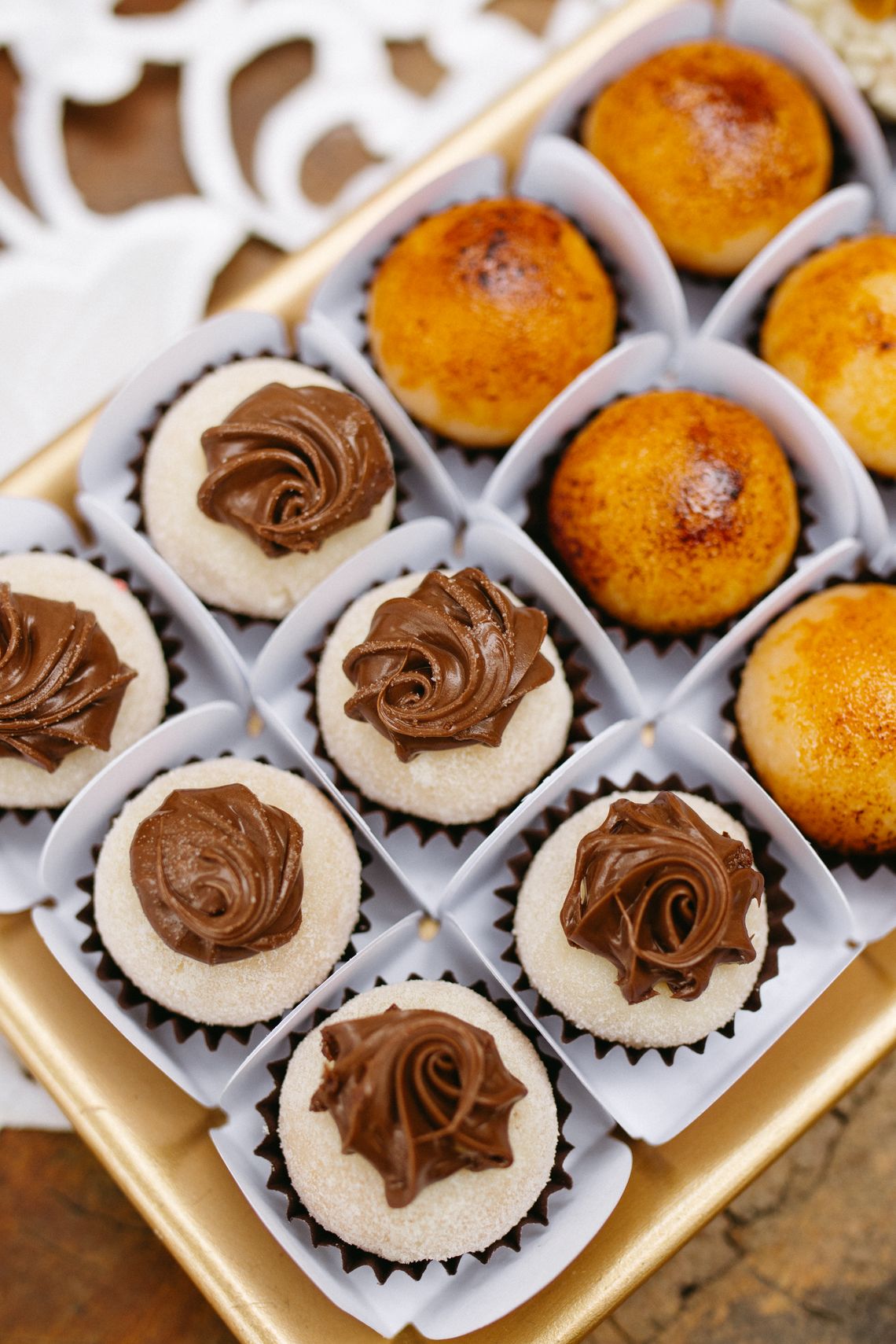 Assorted celebration sweets arranged neatly inside an elegant gift box