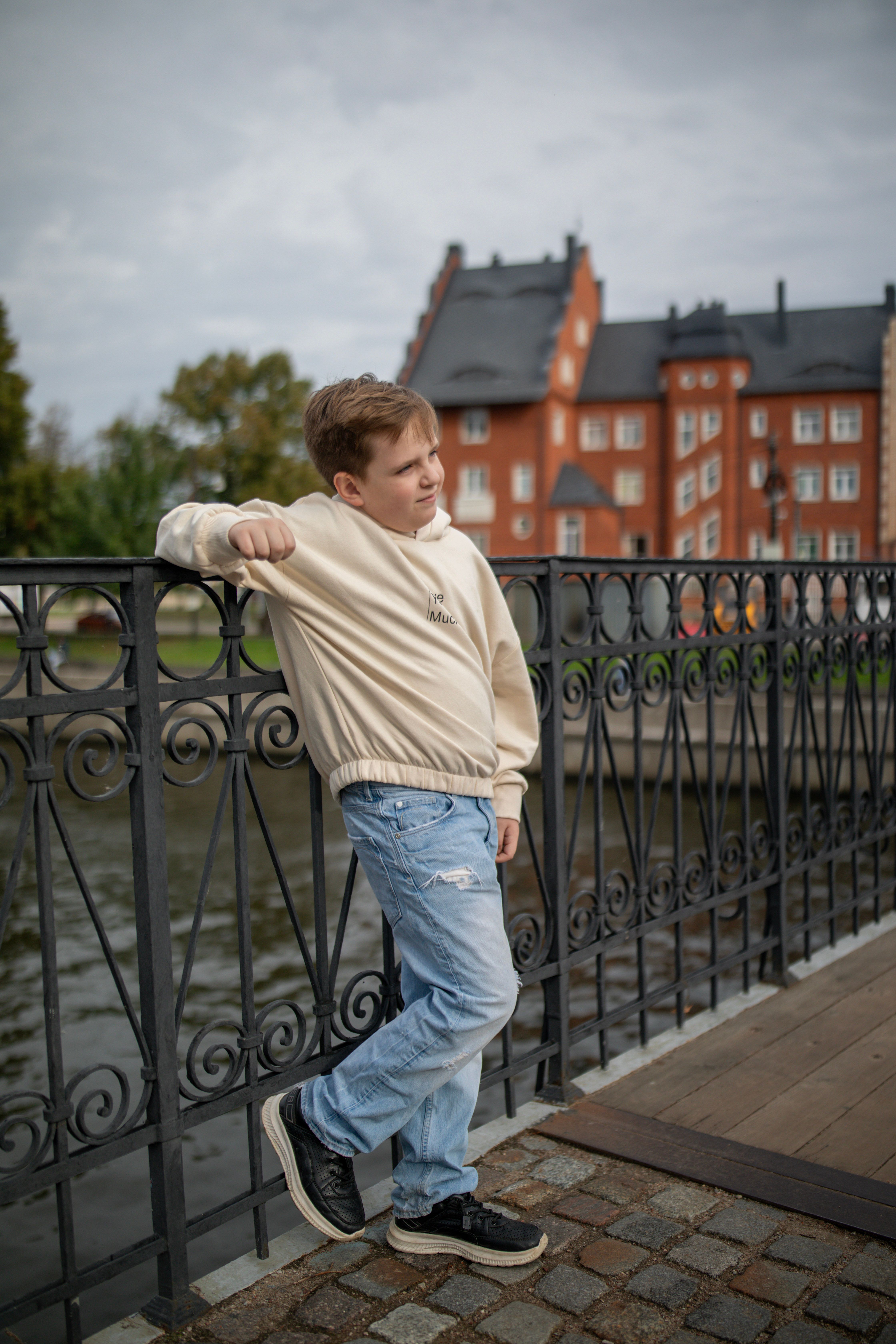 Boy Posing on Bridge in Urban Park Setting · Free Stock Photo