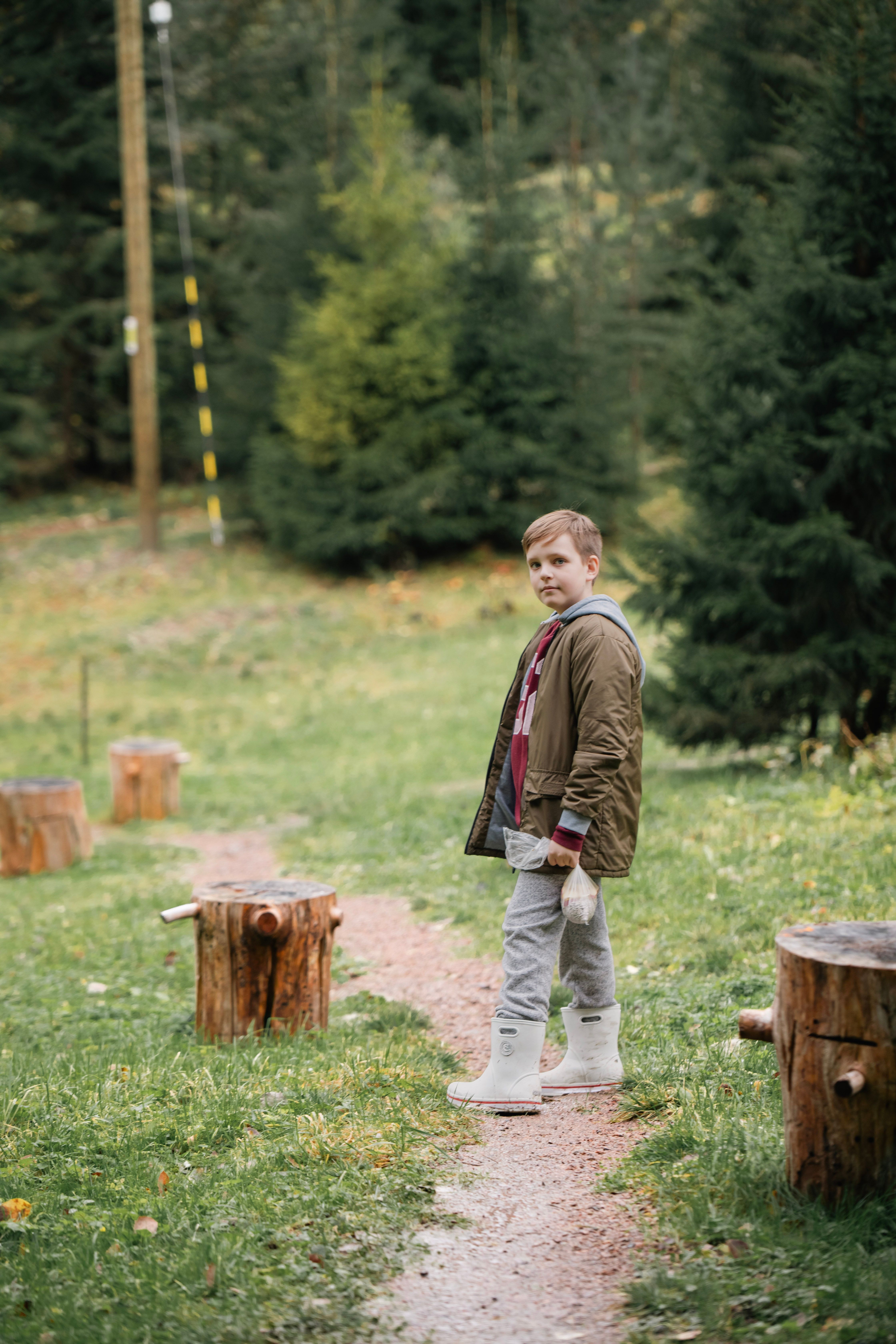 boy-in-forest-pathway-wearing-outdoor-jacket-free-stock-photo