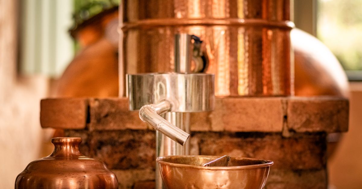 Photo by Tiago Antonio Close-up of copper distillery apparatus with shiny copper bowls.