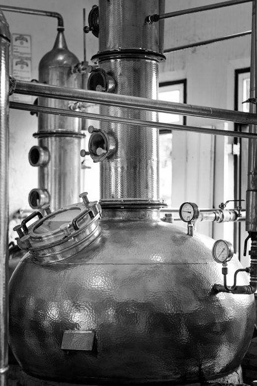 Free Black and white image of large industrial distillery equipment indoors. Stock Photo