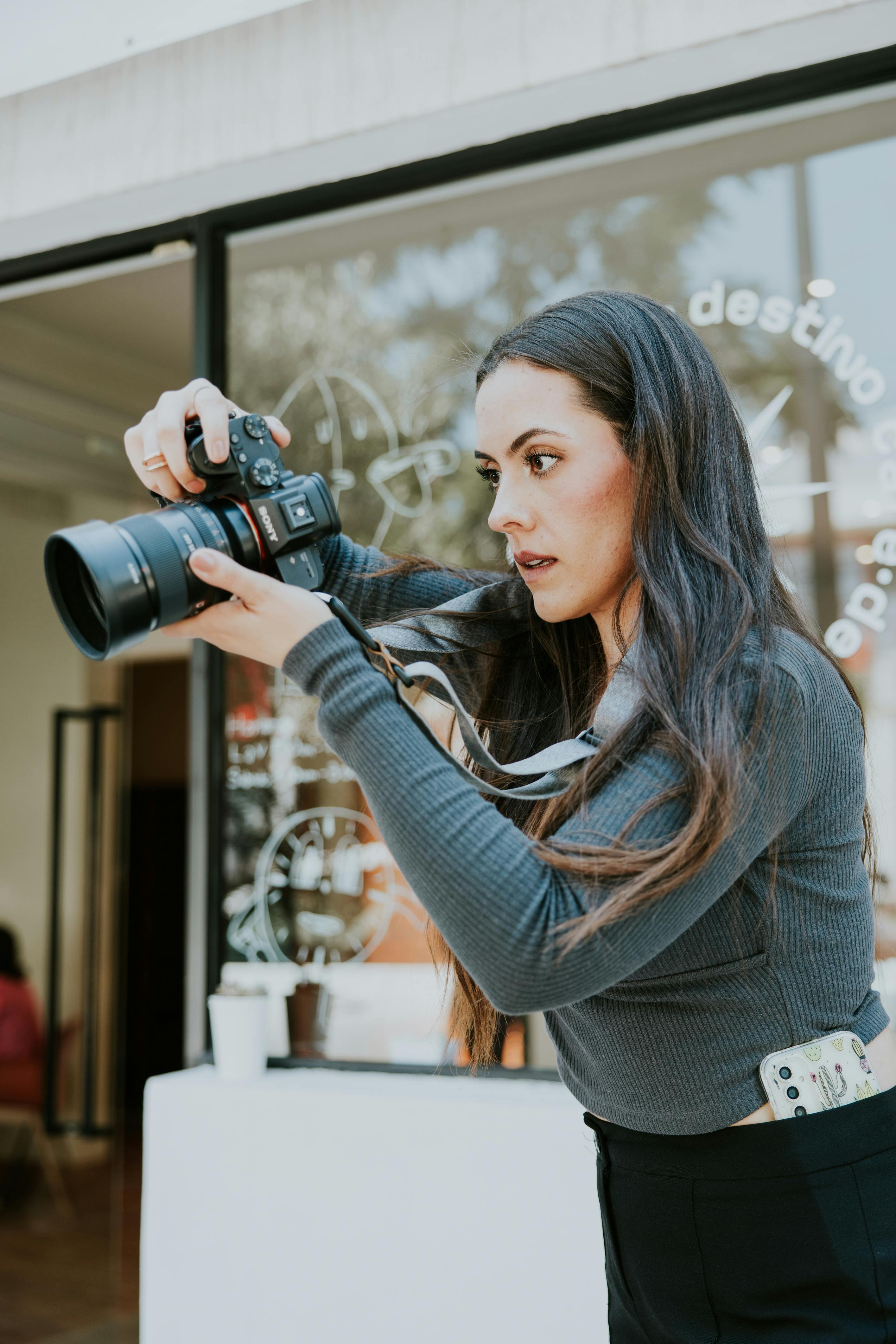 Female photographer capturing moments in a trendy cafe setting.