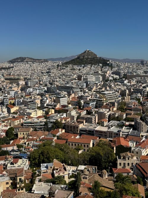 Free Aerial view of Athens showcasing Lycabettus Hill under a clear blue sky. Stock Photo