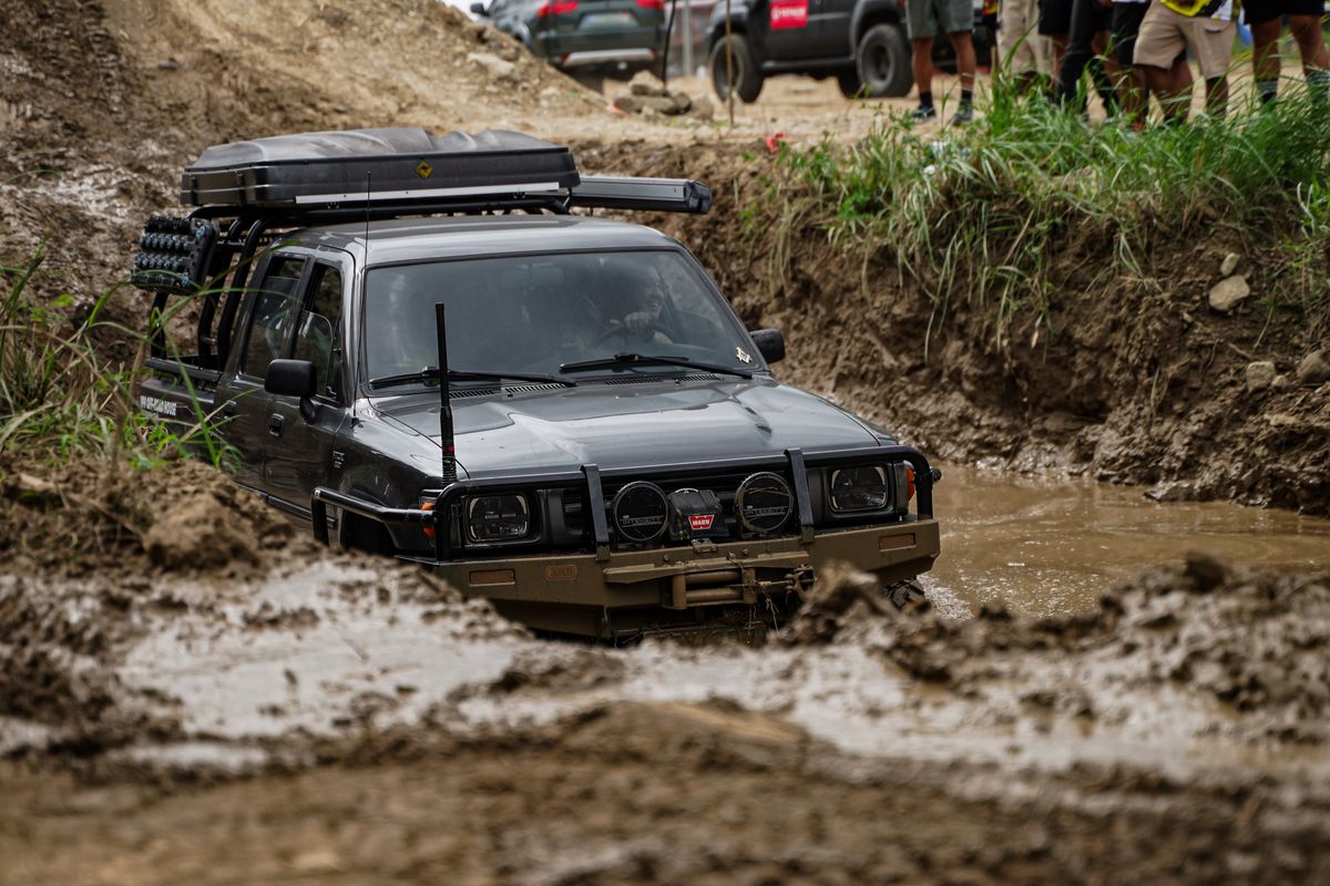 Off-road vehicle stuck in mud during overlanding recovery