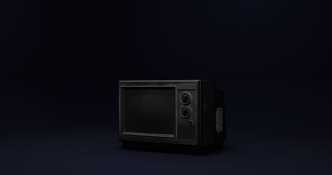 Old CRT television set with knobs, isolated in a dark environment.