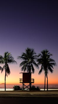 Capture the tranquil beauty of a sunrise over Copacabana Beach in Rio de Janeiro, Brazil.
