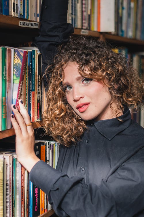 Photo Of Woman Beside Bookshelf