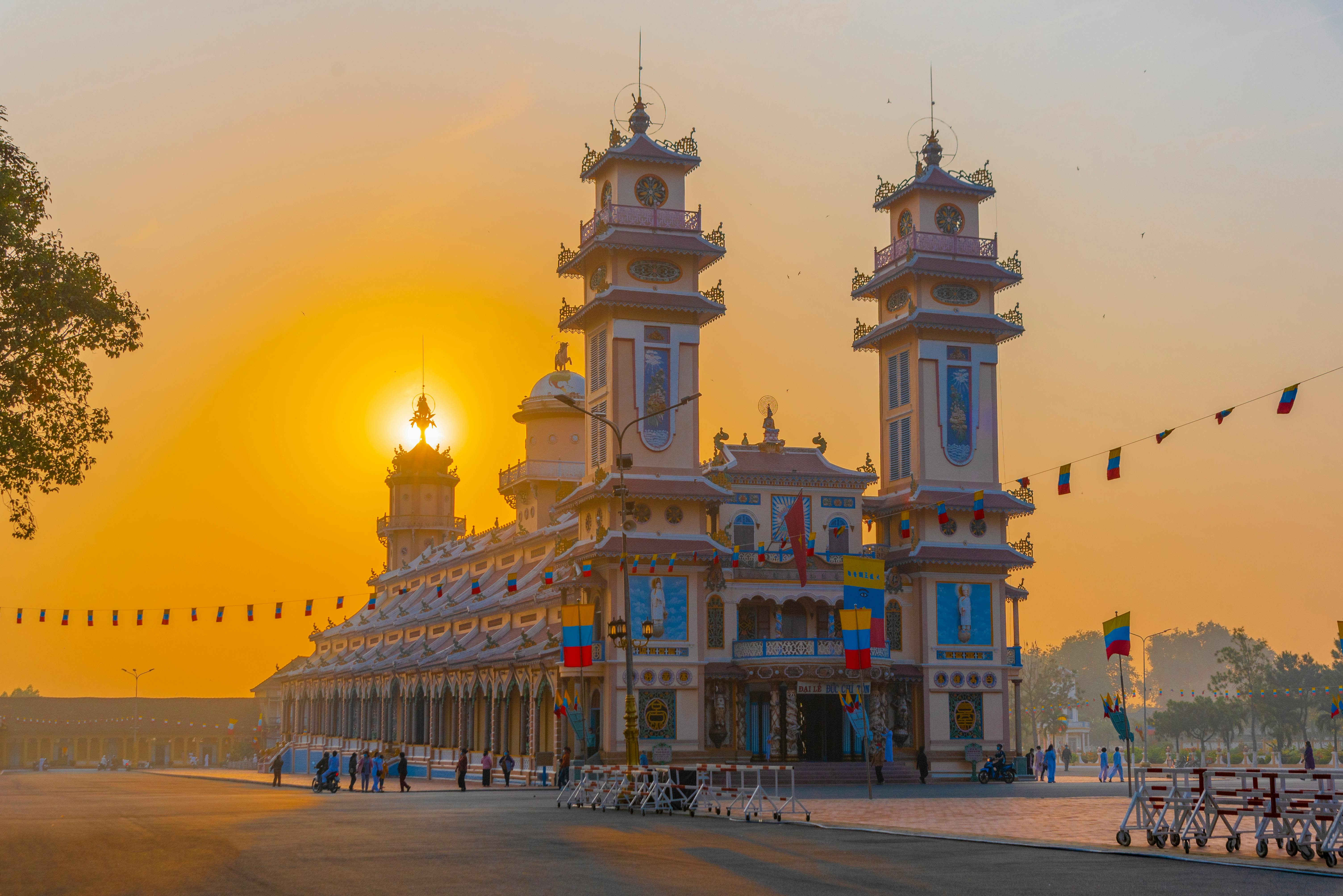 Stunning view of Cao Dai Temple during sunset in Tây Ninh, Vietnam, showcasing its unique architecture.