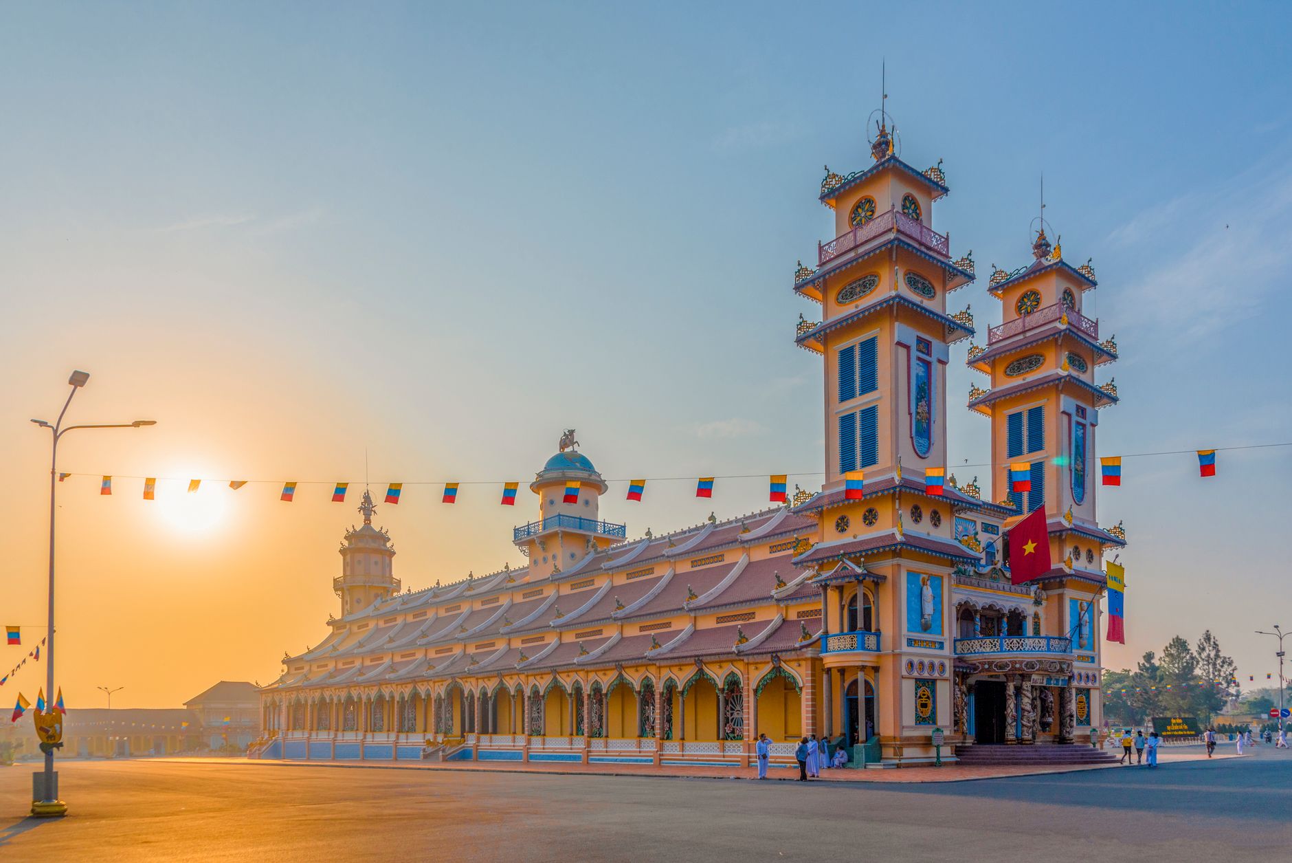 Cao Dai Temple in Tay Ninh, Vietnam, captured at sunrise showcasing its vibrant architecture and cultural significance.