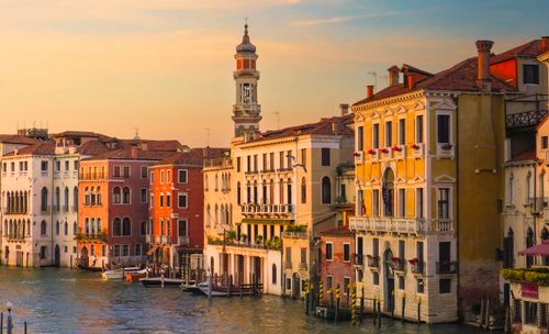 Free Charming Venetian architecture along a canal at sunset, capturing the essence of Venice, Italy. Stock Photo