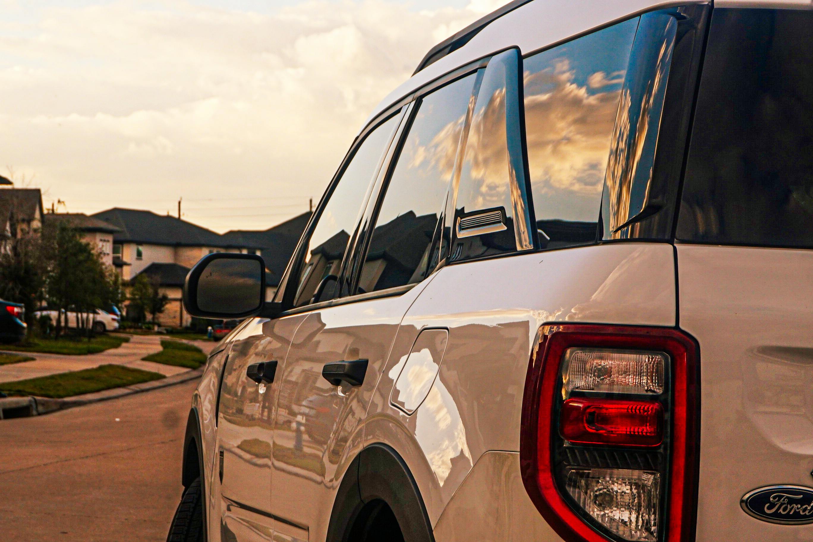 sleek white suv parked in a suburban neighborhood