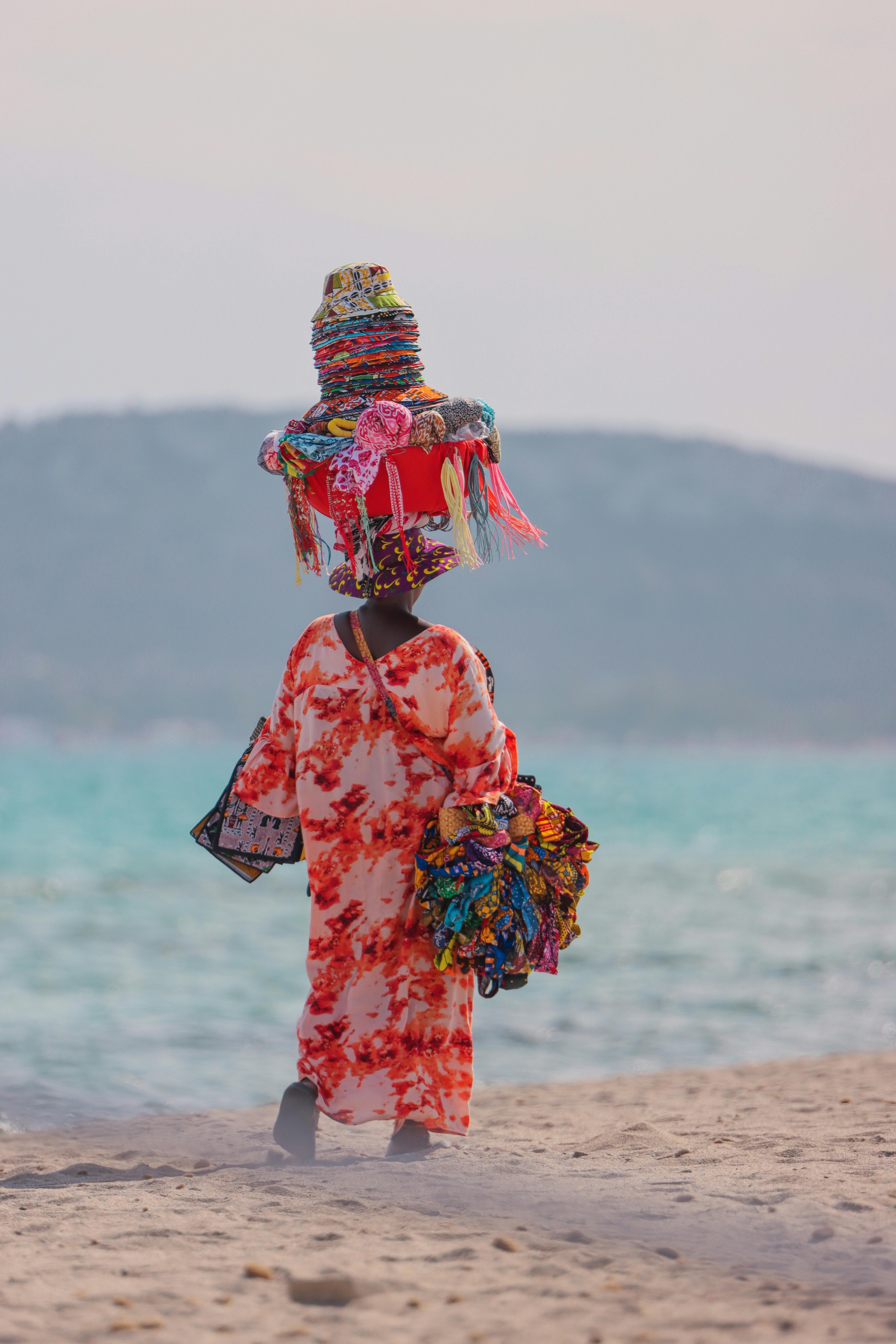 colorful vendor walking on sardinian beach