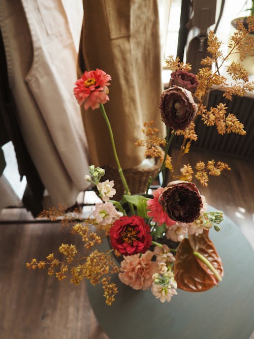 Bouquet of delicate flowers on gray table