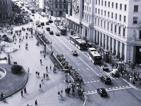 Black and white aerial view of a busy street in Barcelona, capturing daily city life.