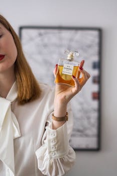 Chic image of a woman displaying a classic Chanel perfume, symbolizing elegance.