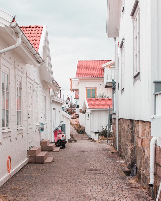 Captivating view of a cobblestone alleyway lined with traditional Swedish houses in Smögen.