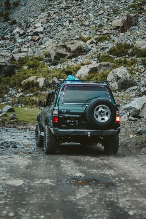 Free 4x4 vehicle navigating rocky terrain in scenic Kalam, Pakistan. Stock Photo