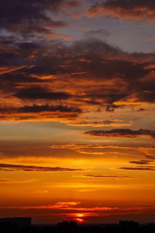 Free Vibrant sunset casting warm colors over the Saint Petersburg skyline, Russia. Stock Photo