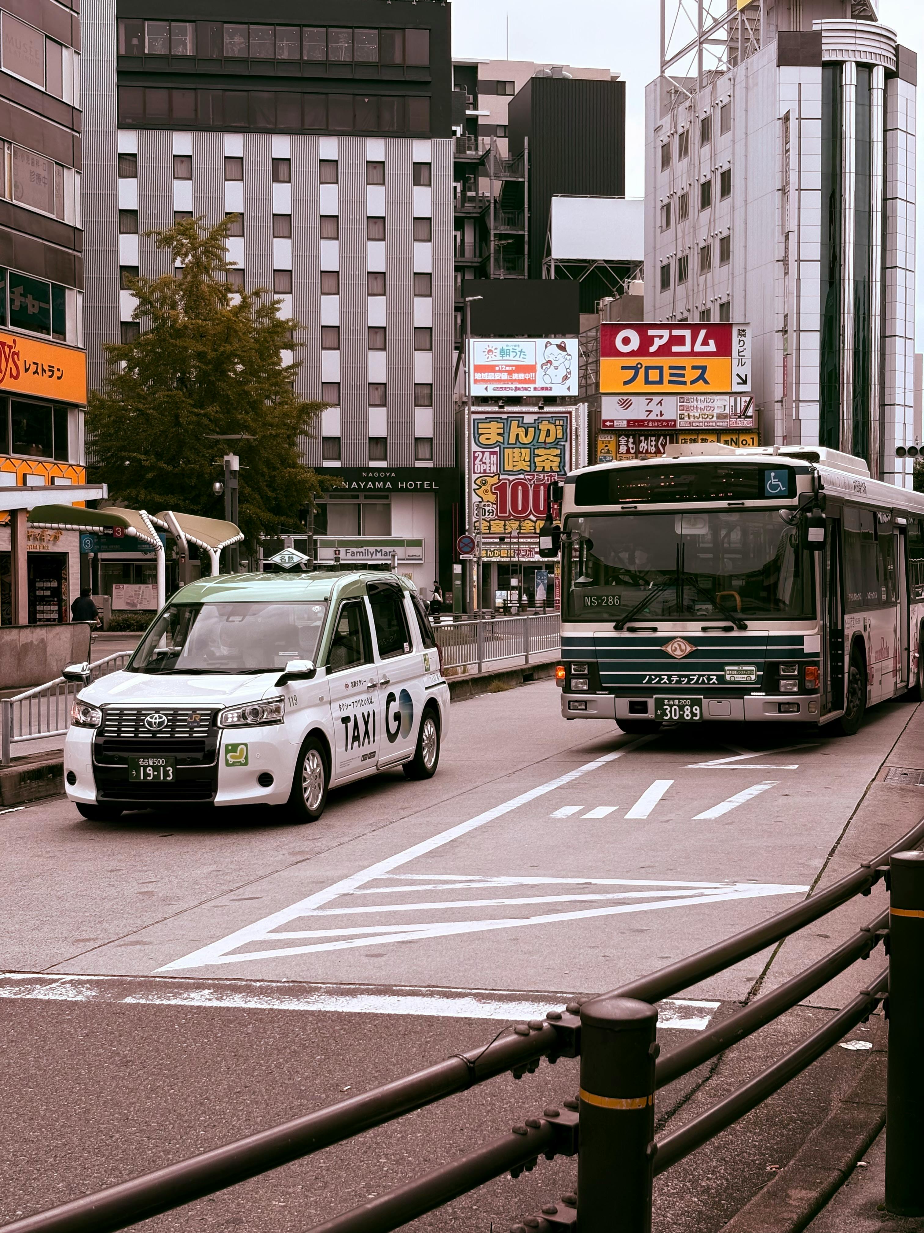 urban street scene with taxi and bus in japan