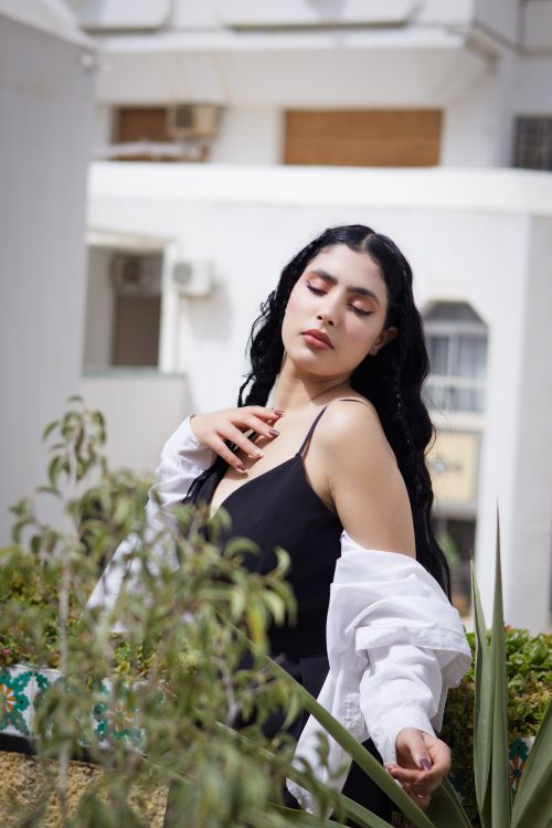 Free Stylish woman posing outdoors in an urban environment, exuding elegance. Stock Photo