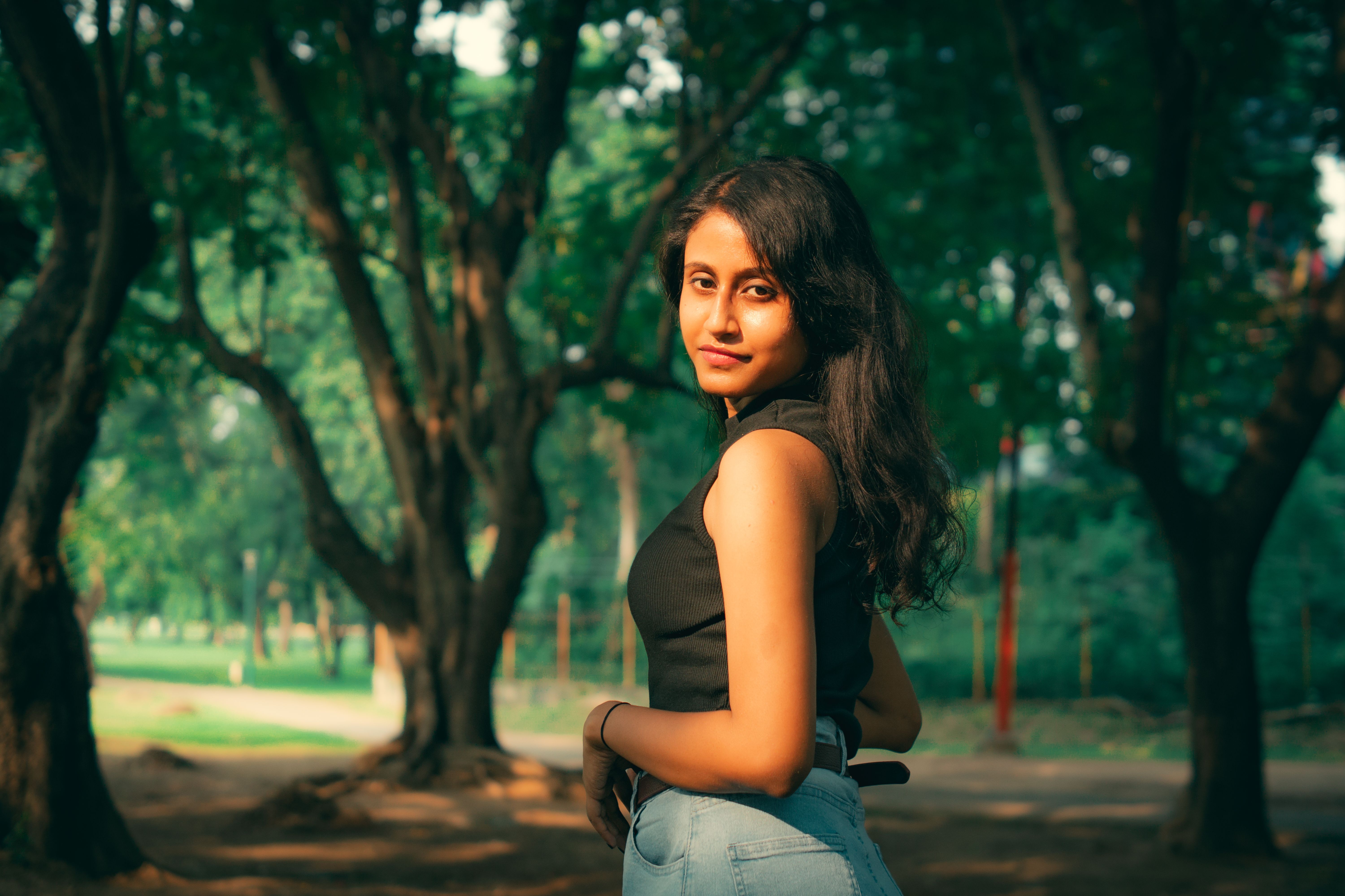 Woman Posing Elegantly Outdoors in Forest Setting · Free Stock Photo