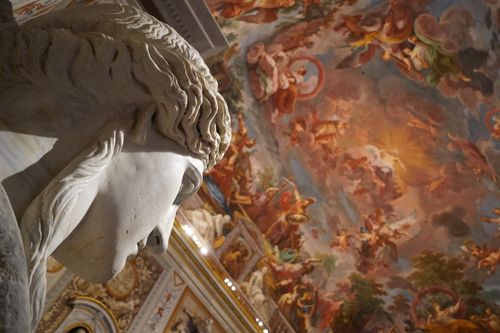 Free Close-up of a marble sculpture with a frescoed ceiling in a museum. Stock Photo