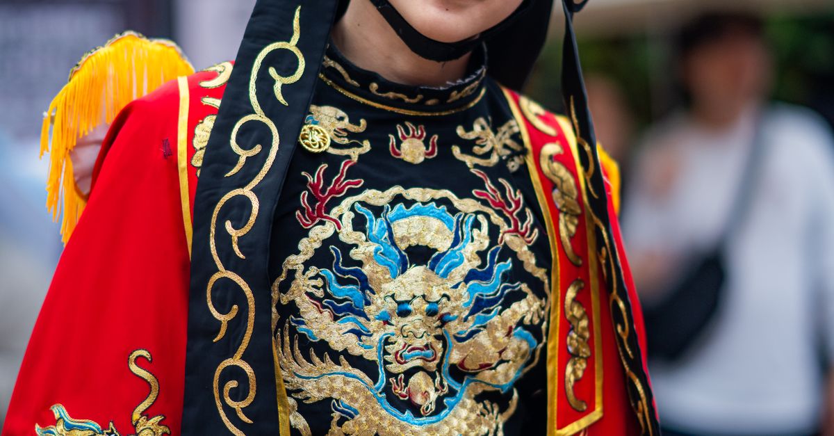 Verona Opera Festival 2026: Experience Magic at Arena di Verona 7 Colorful traditional Chinese opera costume with intricate embroidery and mask.