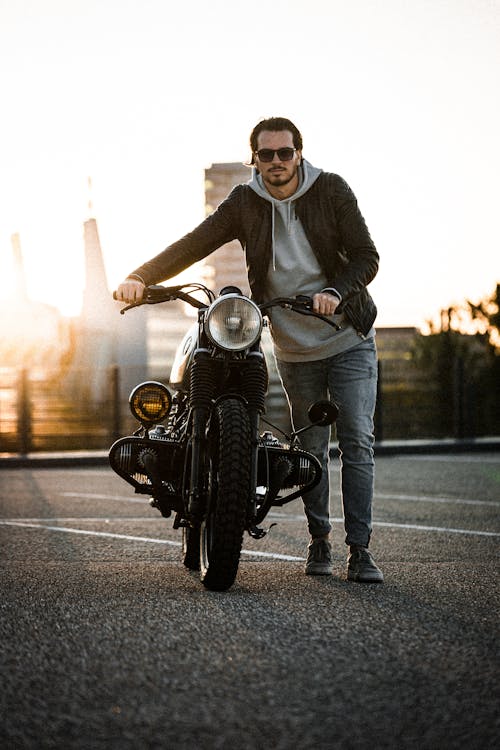 A Man Showing His Bike In A Parking Area