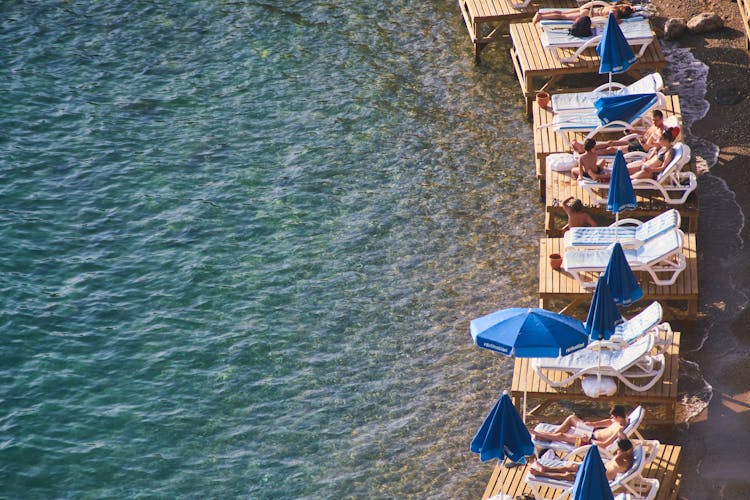 People Relaxing On The Beach