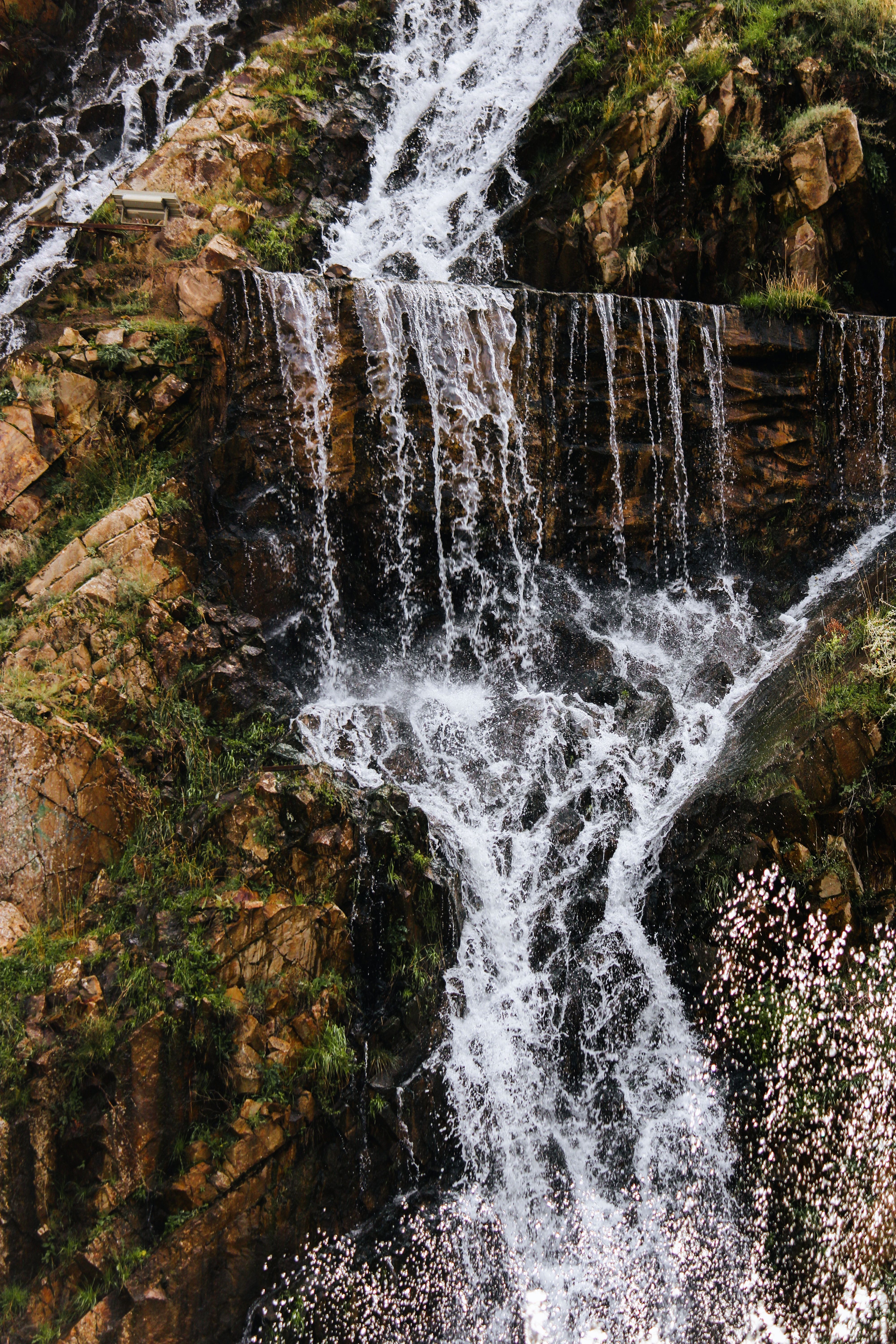 Majestic Waterfall Cascading Over Rocks · Free Stock Photo