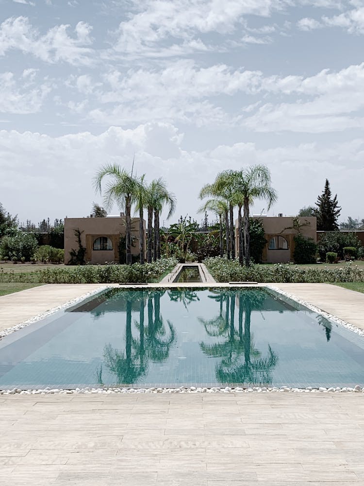 Swimming Pool With Reflection Of Palm Trees