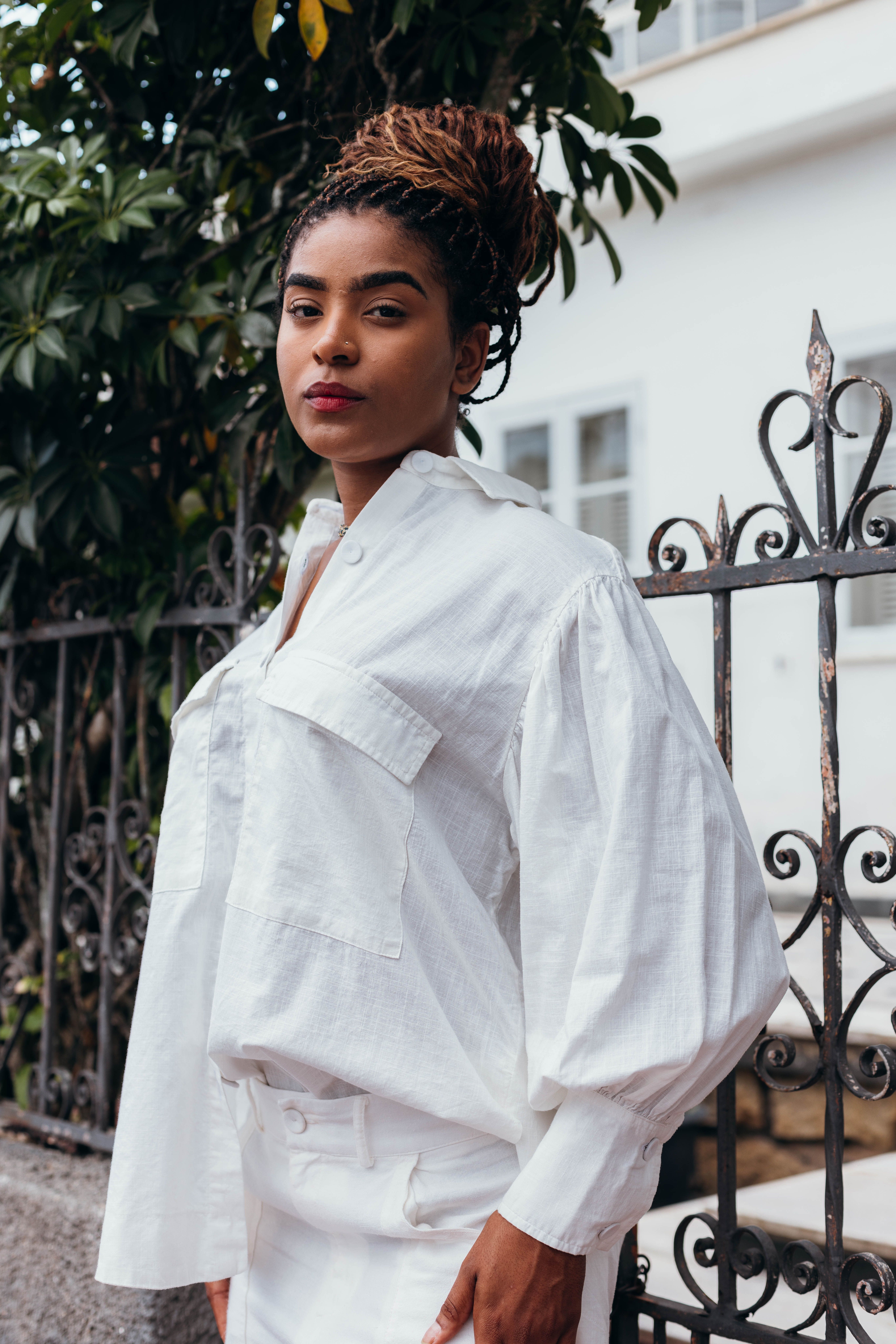 Stylish Woman Posing Outdoors in White Shirt · Free Stock Photo