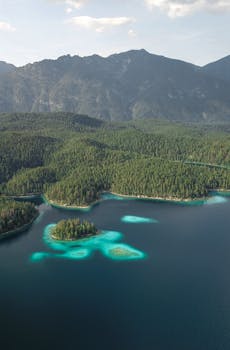 A stunning aerial view of Eibsee Lake in Germany with vibrant waters and mountain backdrop.