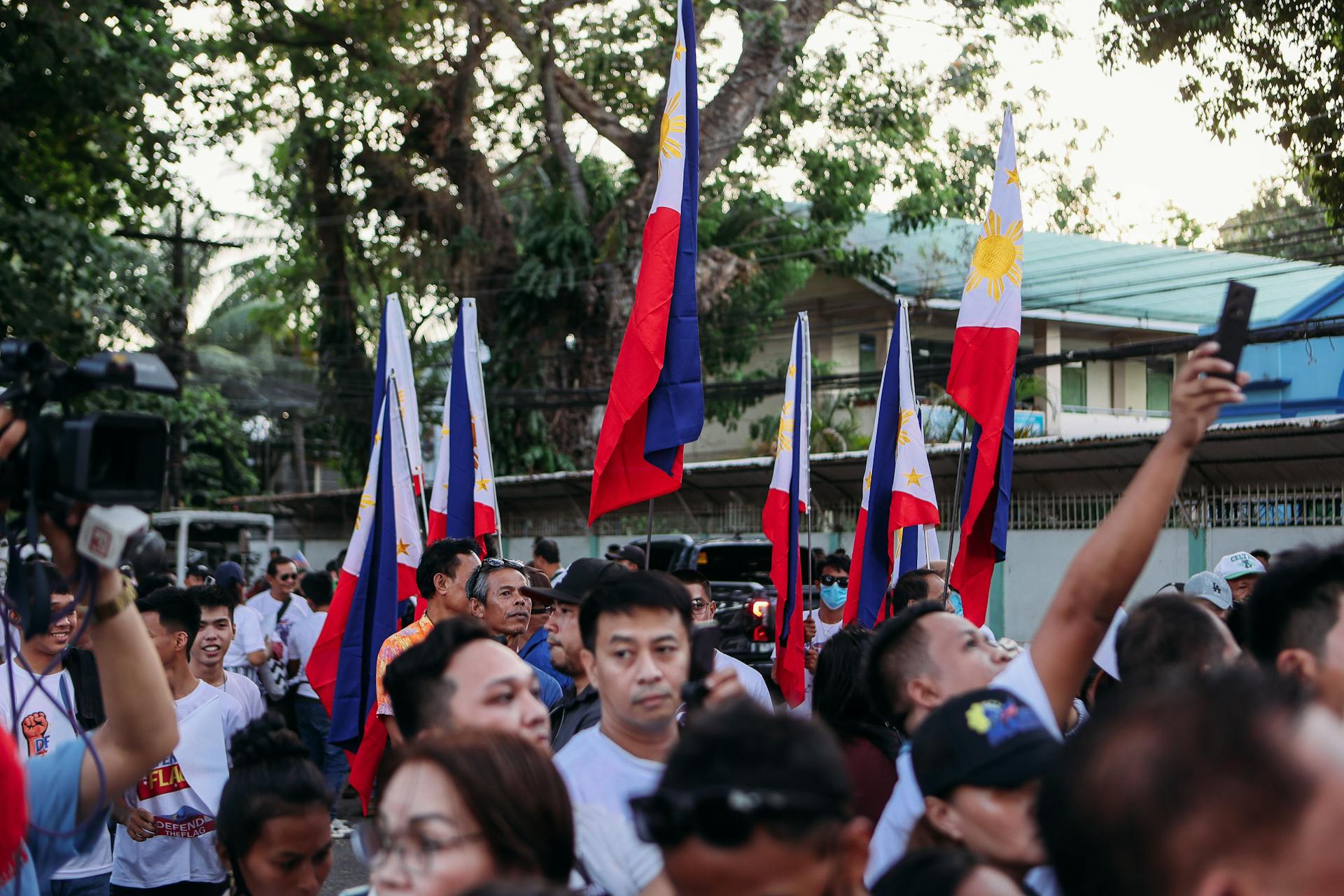Crowd Celebrating with Philippine Flags Outdoors