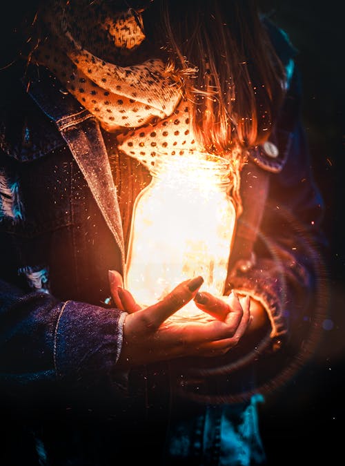 Frau, Die Glasglas Mit Licht Hält