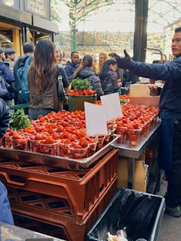 Bustling market scene showcasing fresh strawberries in a lively atmosphere.