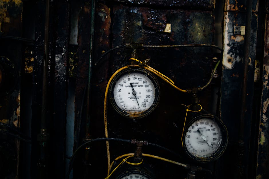 hvac technician checking pressure gauge outdoor unit