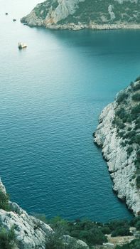 Beautiful coastal scene with rocky cliffs and calm blue waters.