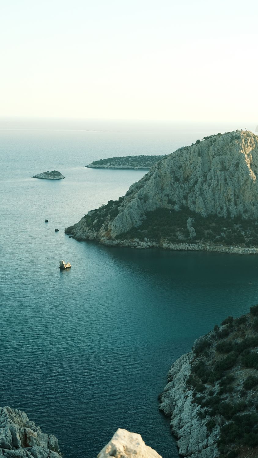 Serene Coastal View with Rocky Cliffs and Blue Sea · Free Stock Photo