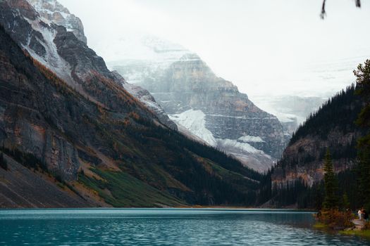 Peaceful mountain scene with turquoise lake surrounded by majestic peaks.