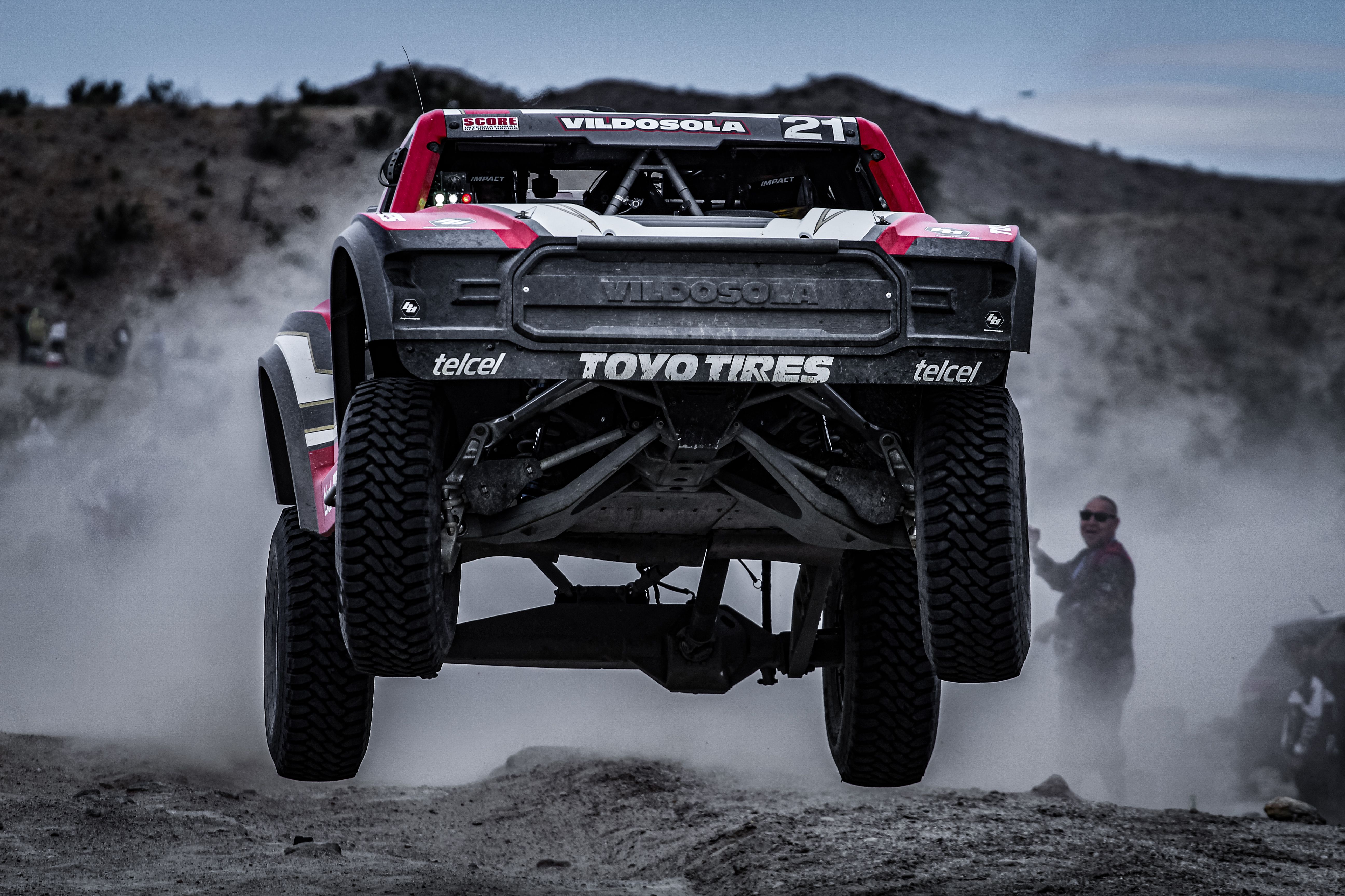 Catch the thrill of a high-speed off-road race truck mid-jump in the Mexicali desert.