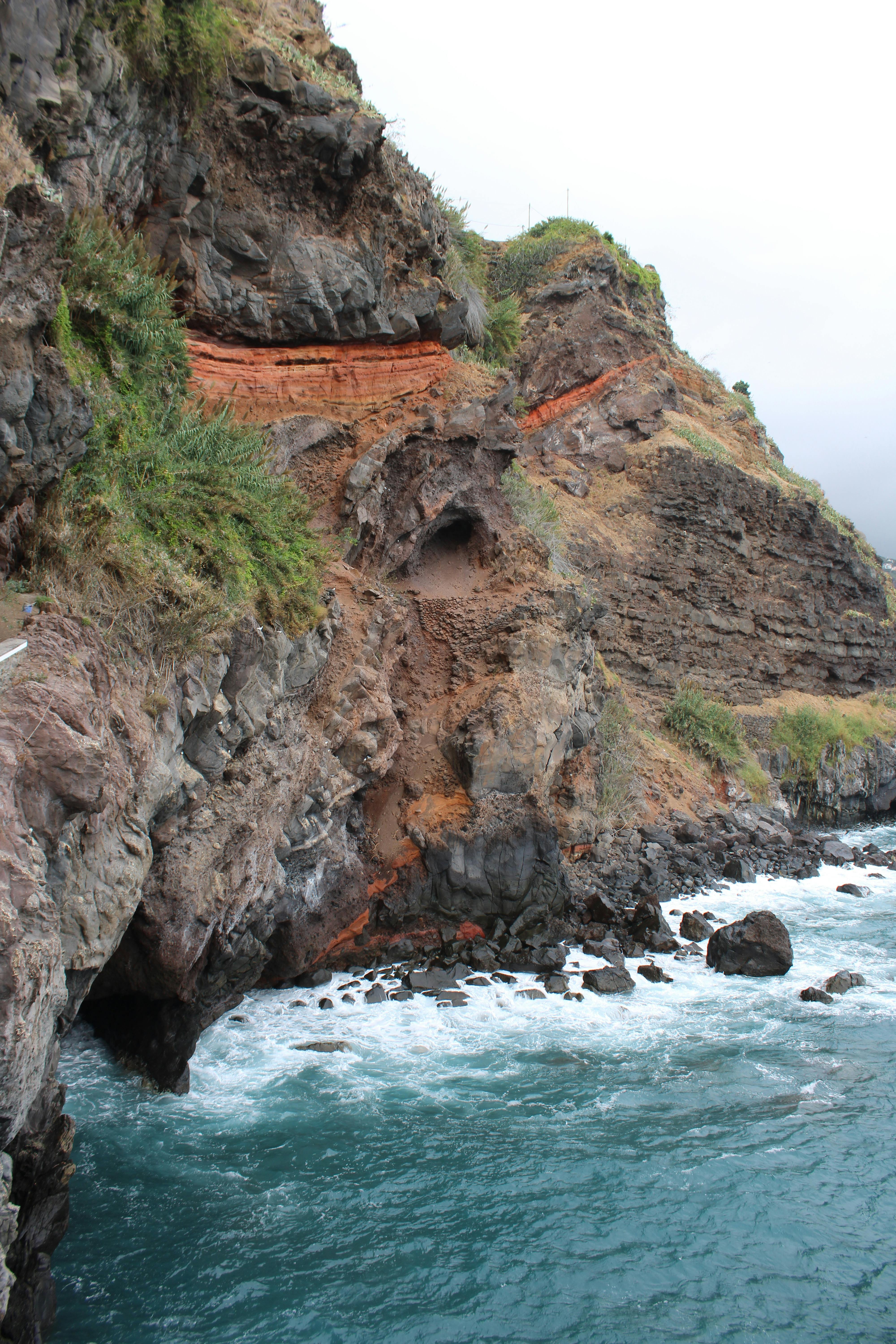 Aerial Madeira coastline with yacht and green cliffs