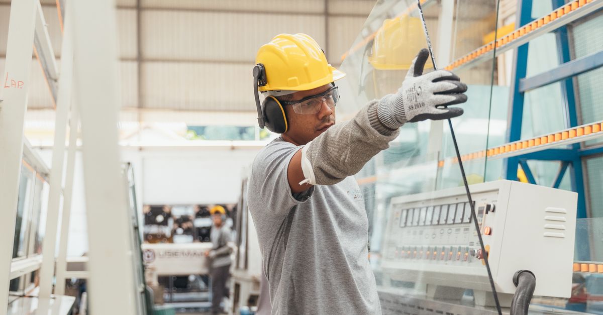 Worker Handling Worker Handling Glass in Industrial Setting · Free Stock Photo